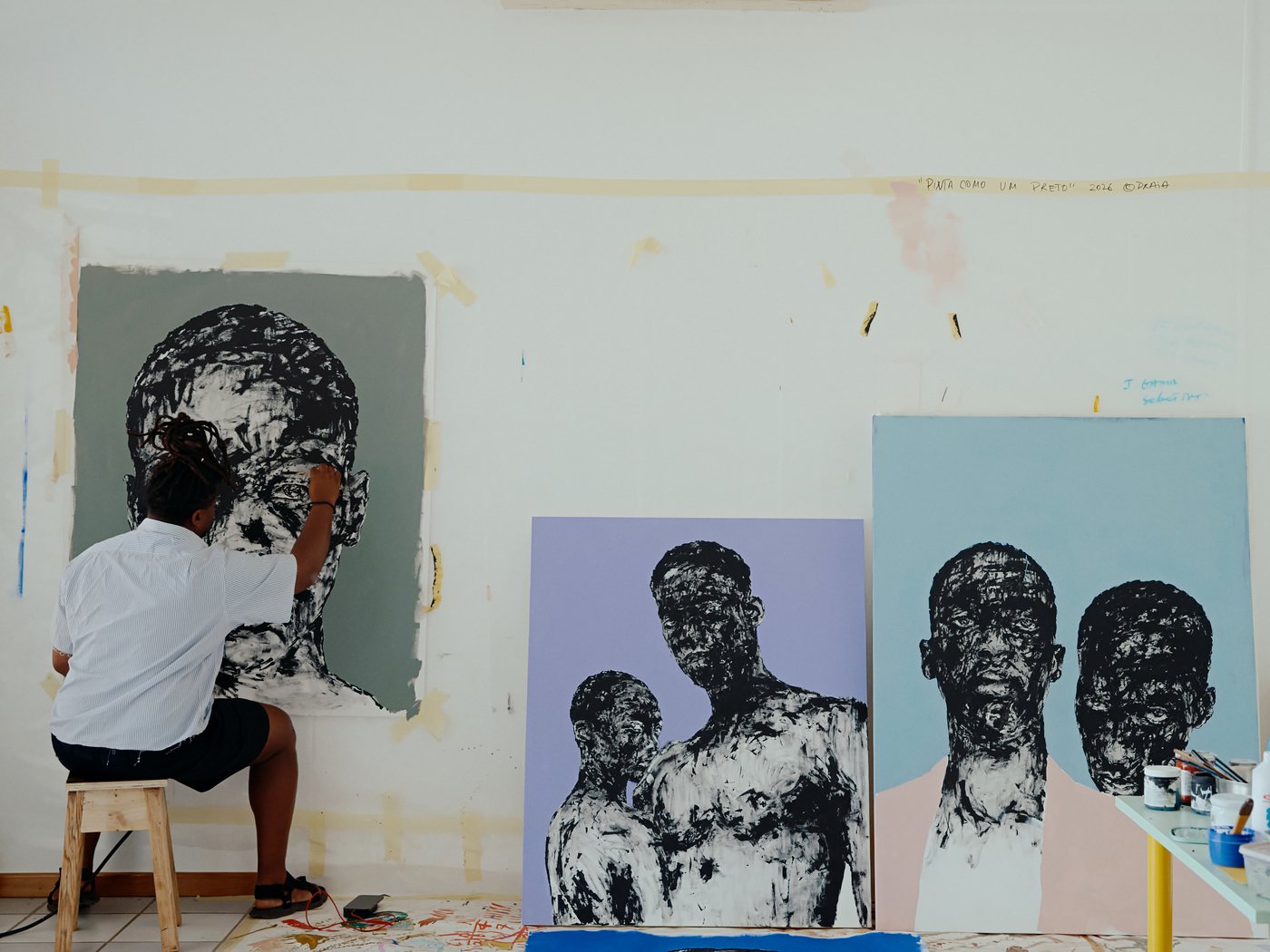 Amadeo Carvalho painting in his studio